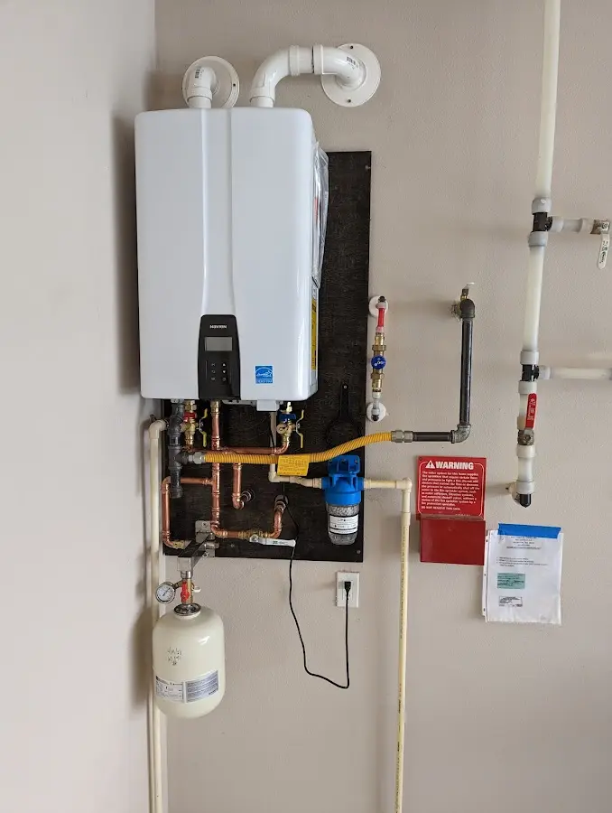 Professional plumber installing copper piping in a Rush home